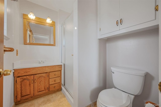 full bathroom with vanity, a shower stall, toilet, and tile patterned floors