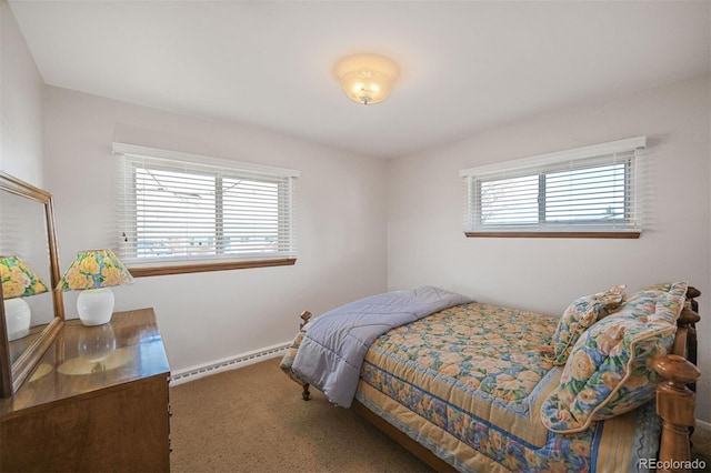 carpeted bedroom featuring a baseboard heating unit