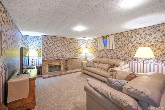 living room featuring wallpapered walls, carpet, and a fireplace