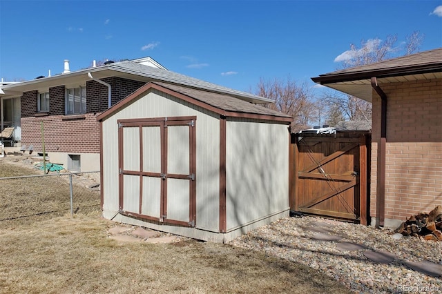 view of shed with fence and a gate