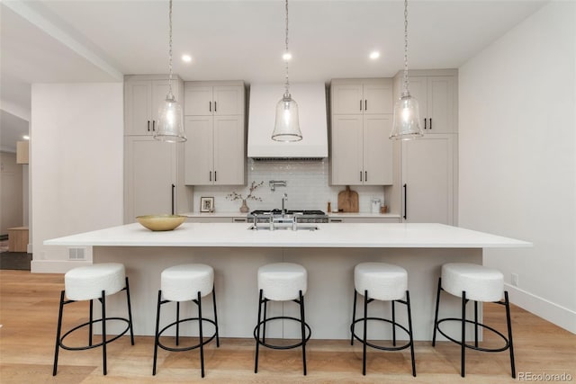 2351 N Emerson St, Denver, CO 80205 - kitchen featuring light countertops, a breakfast bar area, a spacious island, and recessed lighting
