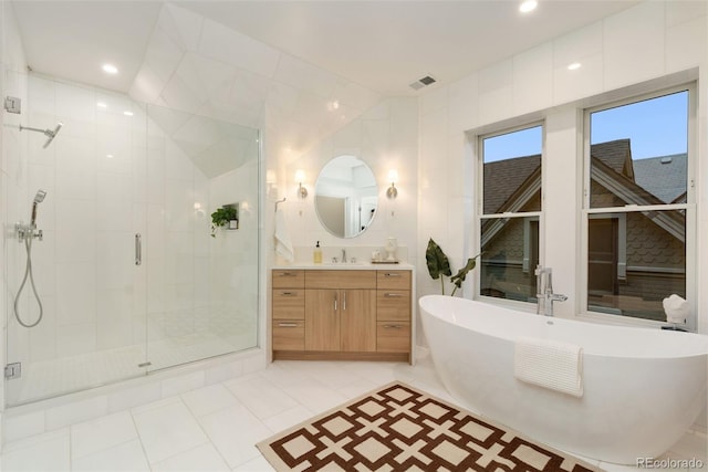 2351 N Emerson St, Denver, CO 80205 - bathroom featuring a shower stall, a freestanding tub, vanity, and tile patterned flooring