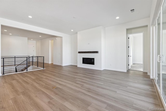 unfurnished living room with light hardwood / wood-style flooring