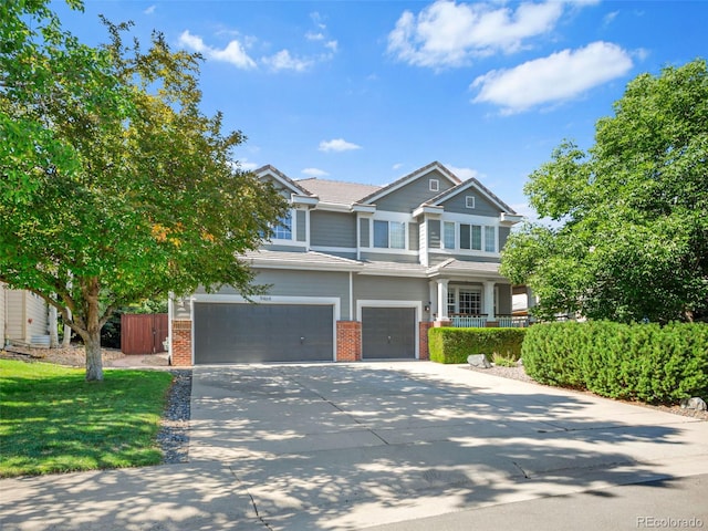 9464 E Aspen Hill Pl, Lone Tree, CO 80124 - view of front facade with brick siding, an attached garage, and driveway