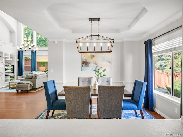 9464 E Aspen Hill Pl, Lone Tree, CO 80124 - dining space with a chandelier, a raised ceiling, and wood finished floors