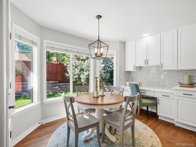 9464 E Aspen Hill Pl, Lone Tree, CO 80124 - dining area featuring plenty of natural light, a chandelier, and dark wood-style floors