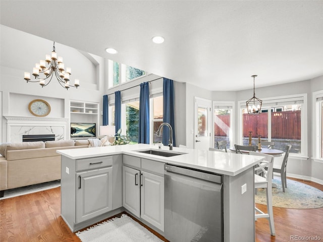 9464 E Aspen Hill Pl, Lone Tree, CO 80124 - kitchen with stainless steel dishwasher, a chandelier, built in shelves, light wood-style flooring, and recessed lighting