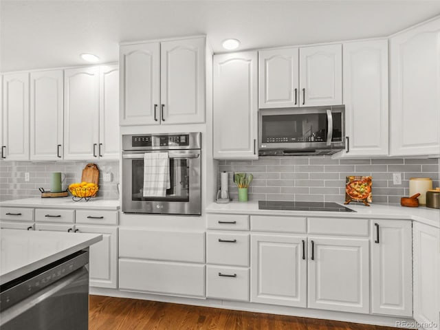9464 E Aspen Hill Pl, Lone Tree, CO 80124 - kitchen featuring stainless steel appliances, backsplash, white cabinets, and light countertops