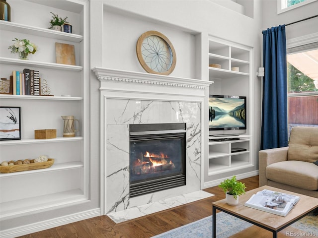 9464 E Aspen Hill Pl, Lone Tree, CO 80124 - living room with a premium fireplace, wood finished floors, and built in features