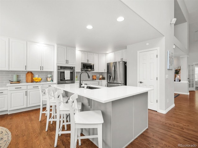 9464 E Aspen Hill Pl, Lone Tree, CO 80124 - kitchen with stainless steel appliances, tasteful backsplash, white cabinets, wood finished floors, and recessed lighting