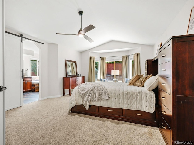 9464 E Aspen Hill Pl, Lone Tree, CO 80124 - bedroom featuring multiple windows, carpet floors, vaulted ceiling, a barn door, and connected bathroom