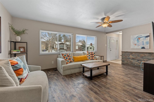 living room featuring a textured ceiling, ceiling fan, and dark hardwood / wood-style floors