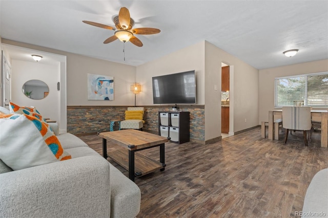 living room with dark wood-type flooring and ceiling fan