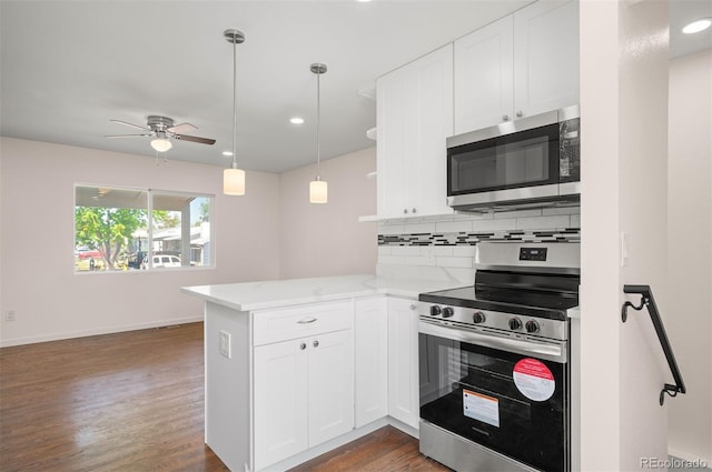 7870 Magnolia St, Commerce City, CO 80022 - kitchen featuring appliances with stainless steel finishes, a peninsula, ceiling fan, white cabinetry, and decorative backsplash