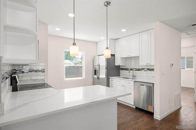 7870 Magnolia St, Commerce City, CO 80022 - kitchen featuring appliances with stainless steel finishes, backsplash, a sink, white cabinetry, and recessed lighting