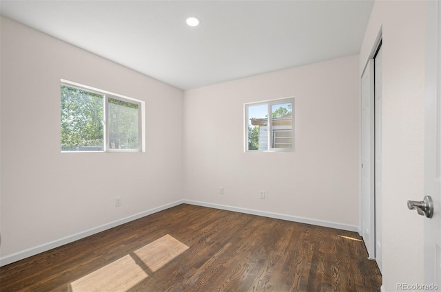 7870 Magnolia St, Commerce City, CO 80022 - unfurnished bedroom featuring baseboards, dark wood-style floors, a closet, and recessed lighting