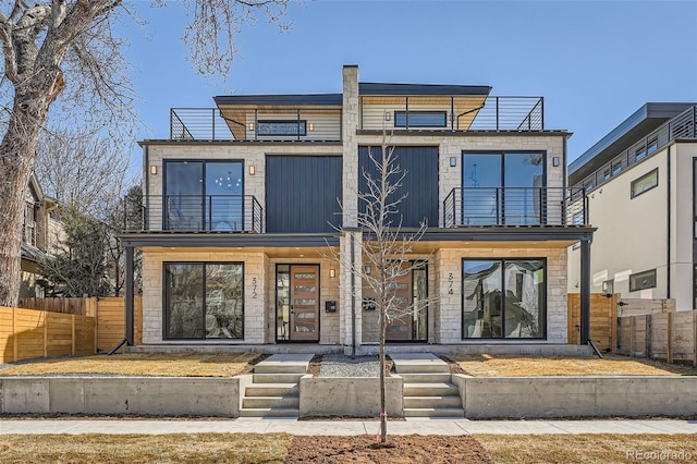 contemporary house with a balcony and fence