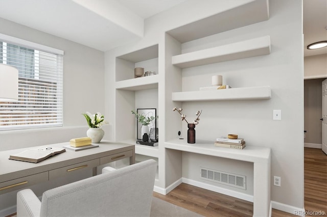 interior space with hardwood / wood-style flooring and built in features