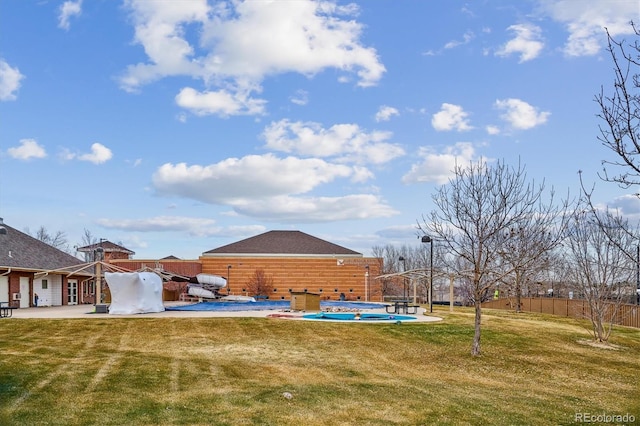 view of yard with a covered pool and a patio