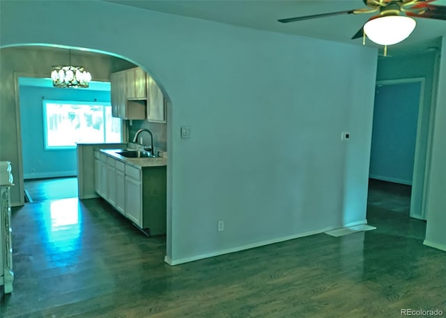 7960 Oneida St, Commerce City, CO 80022 - kitchen featuring a sink, dark wood-type flooring, arched walkways, and ceiling fan