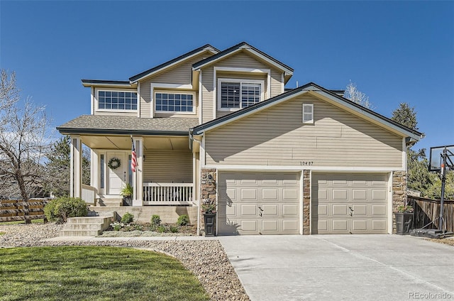view of front of house featuring covered porch, driveway, a garage, fence, and stone siding