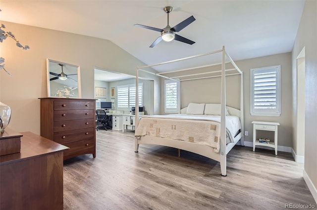 bedroom with baseboards, ceiling fan, vaulted ceiling, and wood finished floors