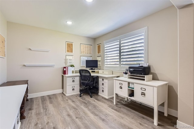 office space featuring baseboards, recessed lighting, and light wood finished floors