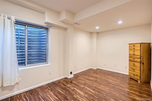 spare room with recessed lighting, baseboards, visible vents, and wood finished floors