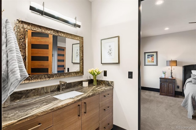 bathroom with vanity, baseboards, and recessed lighting