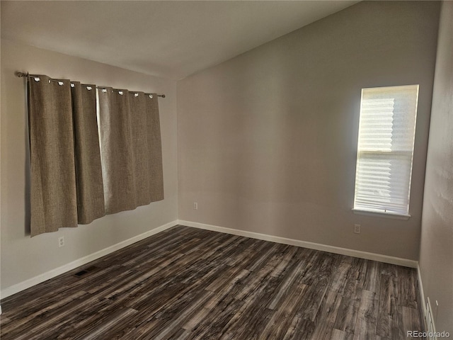 empty room featuring dark hardwood / wood-style flooring