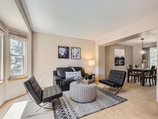 living room with light carpet and baseboards