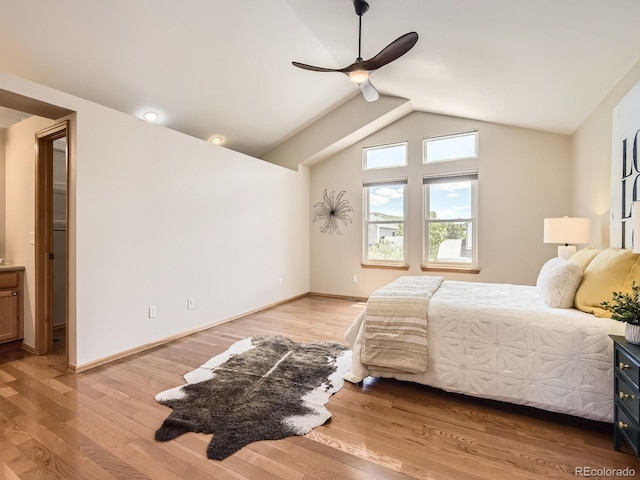 bedroom featuring lofted ceiling, light wood-type flooring, ceiling fan, and baseboards