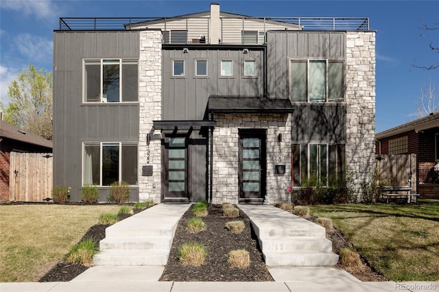 1322 Raleigh St, Denver, CO 80204 - contemporary home featuring board and batten siding, fence, stone siding, and a front lawn