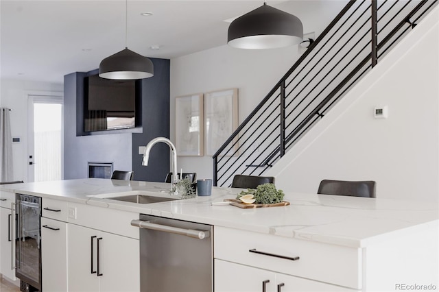 1322 Raleigh St, Denver, CO 80204 - kitchen featuring a sink, stainless steel dishwasher, beverage cooler, and light stone countertops