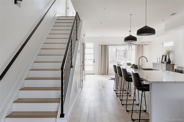 1322 Raleigh St, Denver, CO 80204 - stairway featuring wood finished floors and visible vents