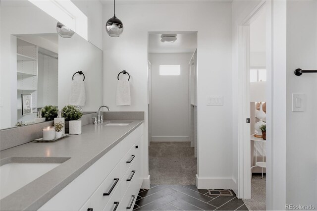 1322 Raleigh St, Denver, CO 80204 - full bathroom with tile patterned flooring, double vanity, visible vents, and a sink