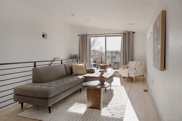 1322 Raleigh St, Denver, CO 80204 - living room featuring light wood-style floors, baseboards, visible vents, and lofted ceiling