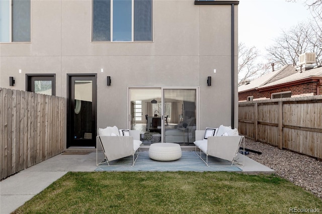 1322 Raleigh St, Denver, CO 80204 - back of property featuring a patio area, stucco siding, a fenced backyard, and a yard