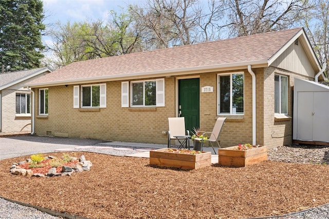 3715 Wolff St, Denver, CO 80212 - ranch-style home with roof with shingles, brick siding, an outbuilding, and a vegetable garden