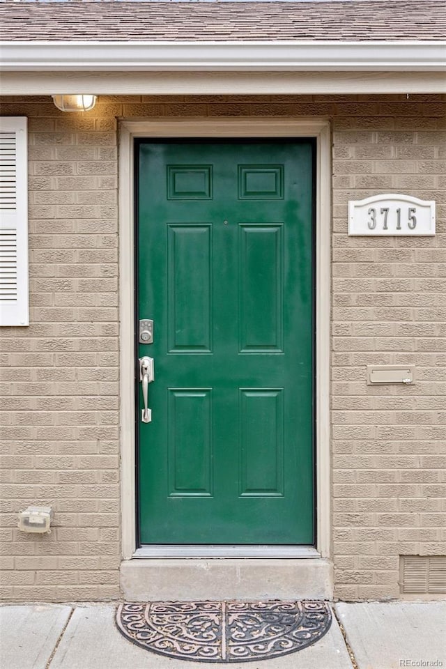 3715 Wolff St, Denver, CO 80212 - doorway to property with brick siding