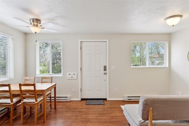 3715 Wolff St, Denver, CO 80212 - dining area featuring baseboard heating, wood finished floors, ceiling fan, a textured ceiling, and baseboards