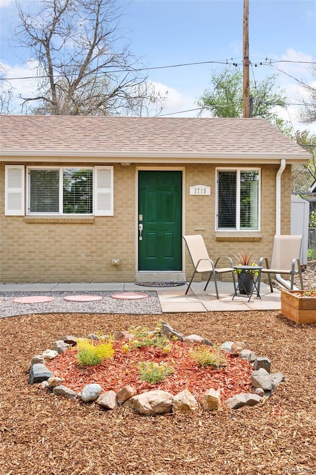 3715 Wolff St, Denver, CO 80212 - view of front of home with brick siding and roof with shingles