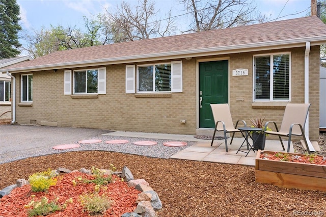 3715 Wolff St, Denver, CO 80212 - back of property featuring brick siding, a shingled roof, and a patio