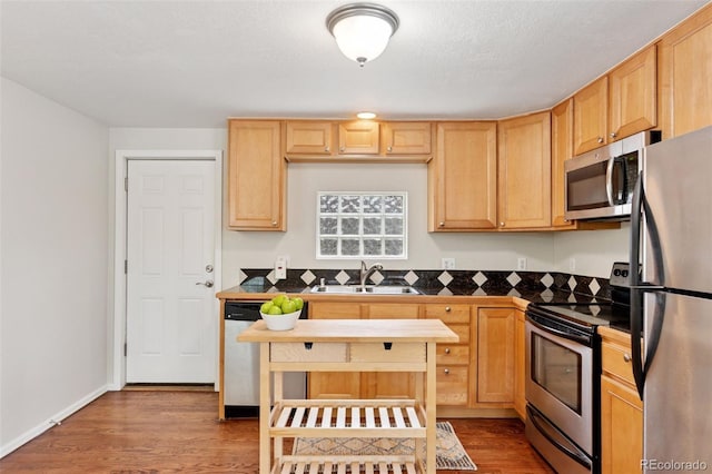 3715 Wolff St, Denver, CO 80212 - kitchen featuring appliances with stainless steel finishes, a sink, wood finished floors, and light brown cabinetry