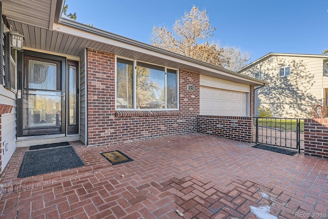 doorway to property with a garage