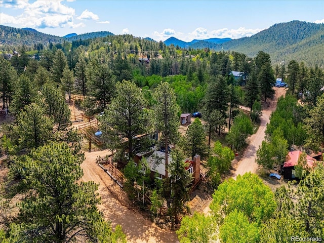 aerial view featuring a mountain view and a view of trees