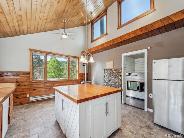 366 Houston St, Bailey, CO 80421 - kitchen with freestanding refrigerator, a ceiling fan, wooden counters, baseboard heating, and white cabinets