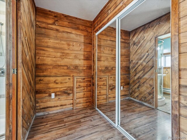 366 Houston St, Bailey, CO 80421 - interior space with wood walls, wood finished floors, and baseboard heating