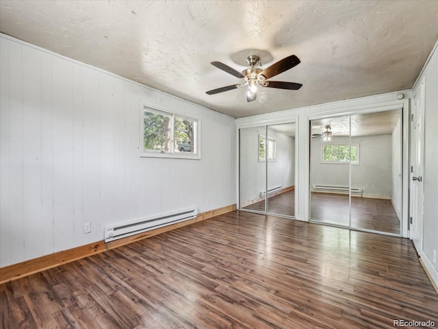 366 Houston St, Bailey, CO 80421 - unfurnished bedroom featuring a baseboard radiator, multiple closets, and wood finished floors