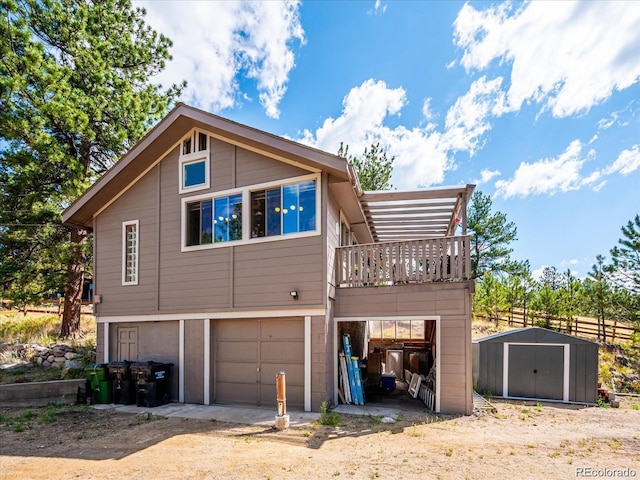 366 Houston St, Bailey, CO 80421 - rear view of house featuring a shed, a garage, dirt driveway, and an outbuilding